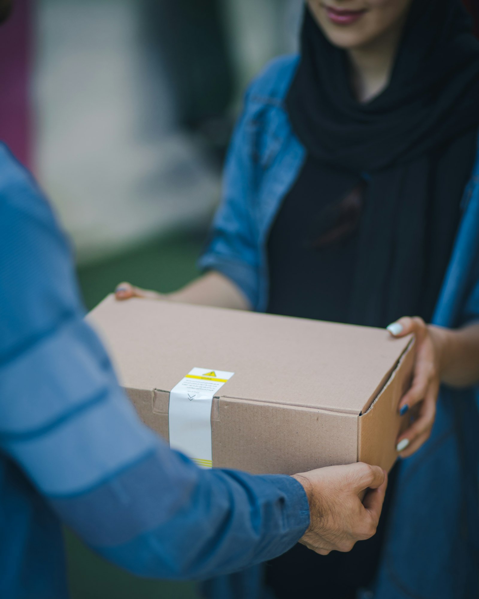 Customer receiving a packed order in a cardboard box