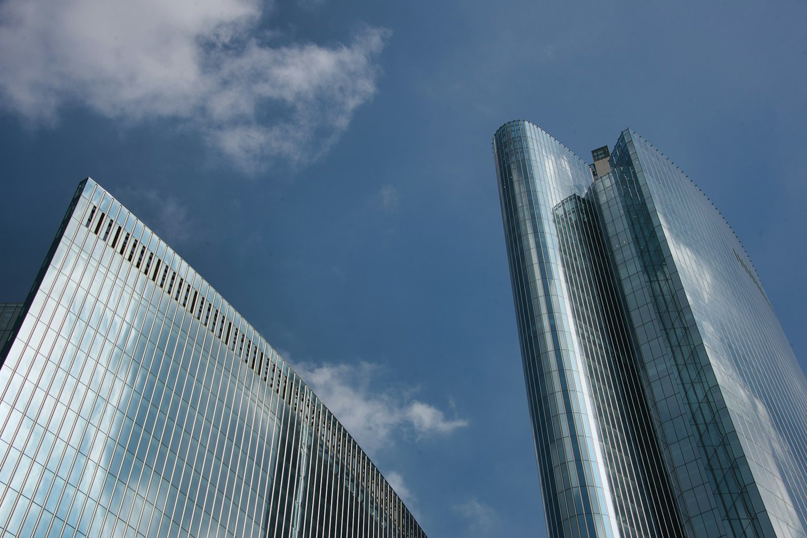 Glass office towers against a blue sky