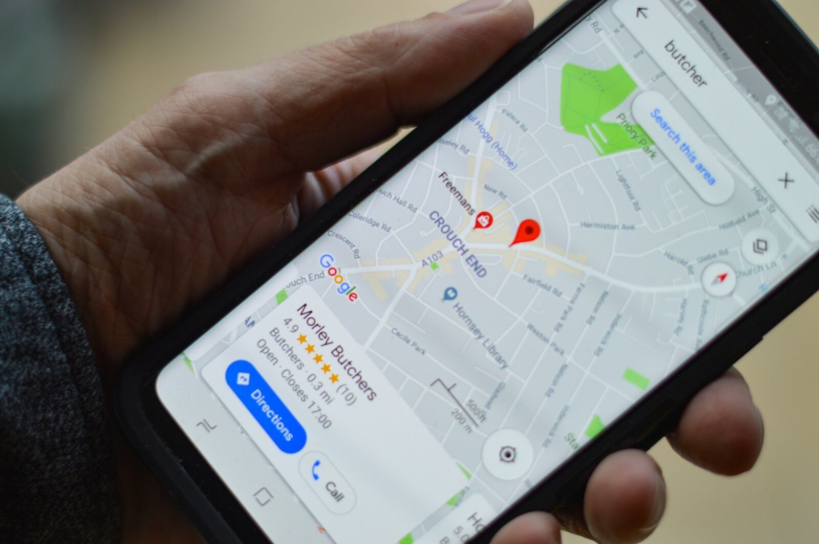 Phone showing a business listing with star rating on Google Maps
